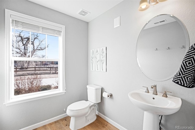 bathroom featuring toilet and hardwood / wood-style flooring