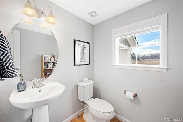 bathroom featuring toilet and sink