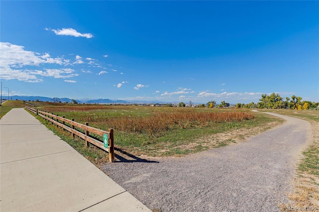 view of street with a rural view and a mountain view