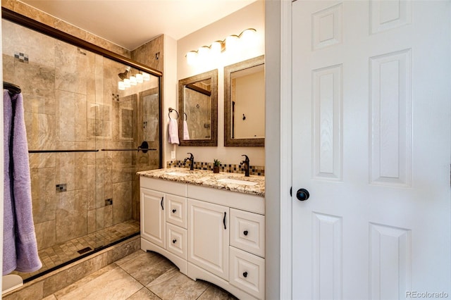 8500 E Jefferson Ave Unit 19B, Denver, CO 80237 - bathroom featuring a stall shower, double vanity, and tile patterned floors