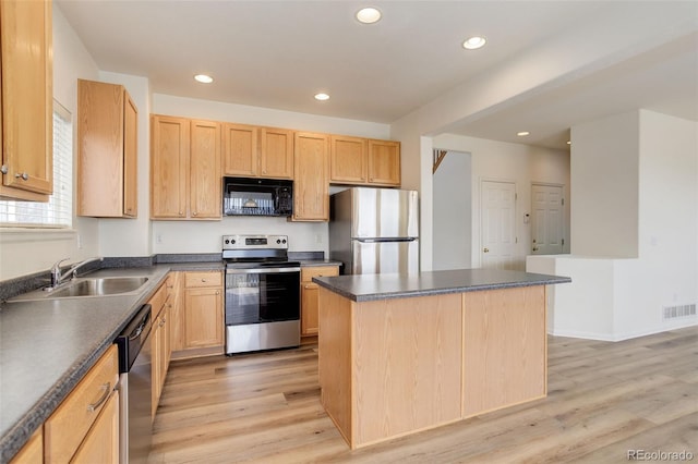 21968 E Princeton Dr, Aurora, CO 80018 - kitchen featuring appliances with stainless steel finishes, a sink, light brown cabinetry, dark countertops, and recessed lighting