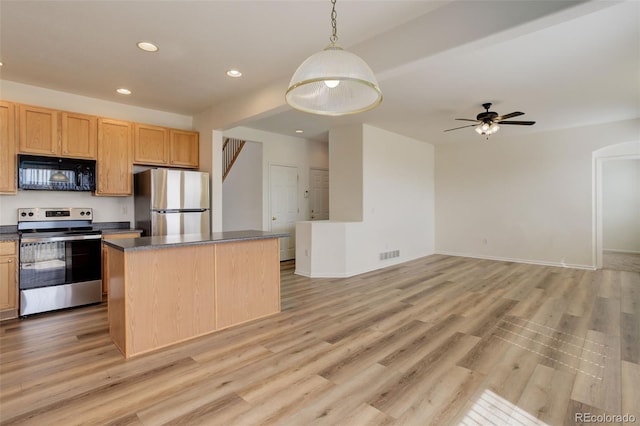 21968 E Princeton Dr, Aurora, CO 80018 - kitchen with appliances with stainless steel finishes, dark countertops, recessed lighting, a center island, and open floor plan