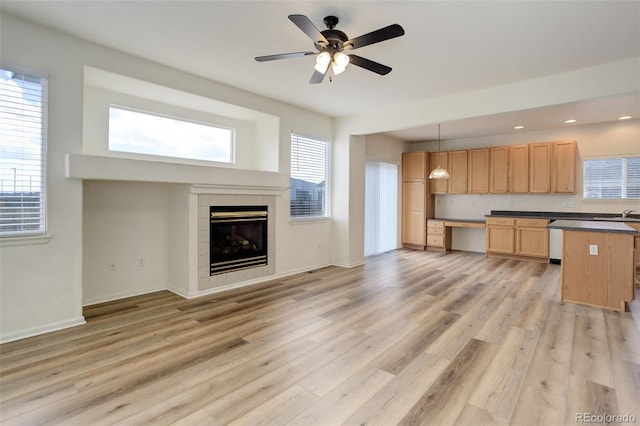 21968 E Princeton Dr, Aurora, CO 80018 - unfurnished living room with light wood-style flooring, plenty of natural light, ceiling fan, a tile fireplace, and recessed lighting