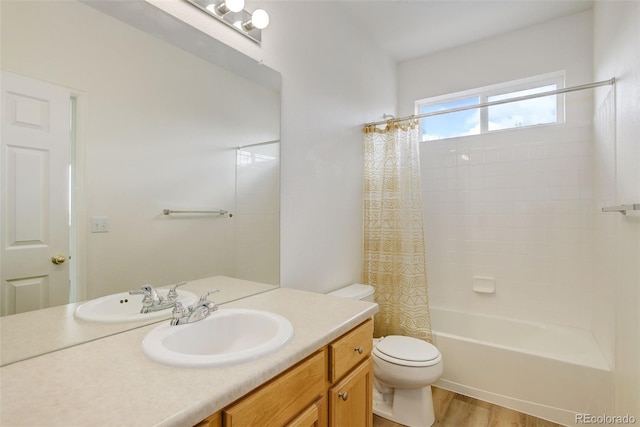 21968 E Princeton Dr, Aurora, CO 80018 - bathroom featuring toilet, wood finished floors, vanity, and shower / tub combo