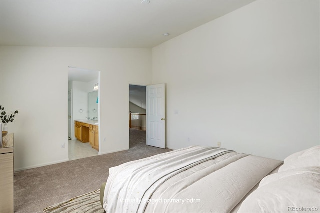 21968 E Princeton Dr, Aurora, CO 80018 - bedroom with vaulted ceiling, light colored carpet, baseboards, and ensuite bath