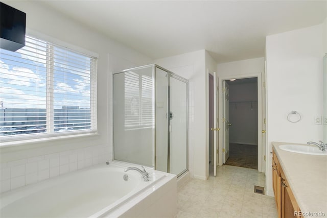 21968 E Princeton Dr, Aurora, CO 80018 - full bathroom featuring healthy amount of natural light, a shower stall, vanity, and a walk in closet