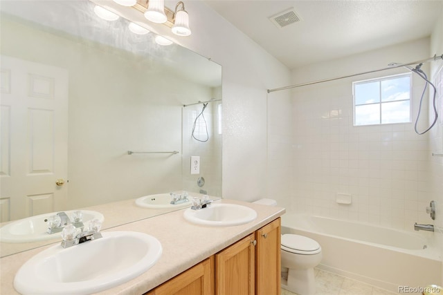 21968 E Princeton Dr, Aurora, CO 80018 - bathroom featuring shower / bath combination, toilet, double vanity, and tile patterned floors