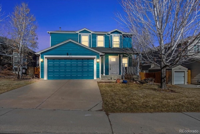 traditional-style home featuring driveway and an attached garage