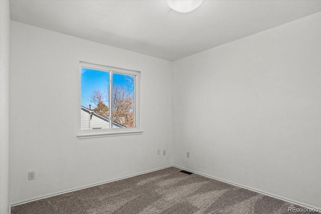 carpeted empty room featuring visible vents