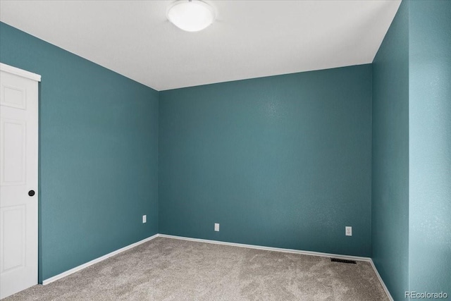 carpeted empty room with baseboards