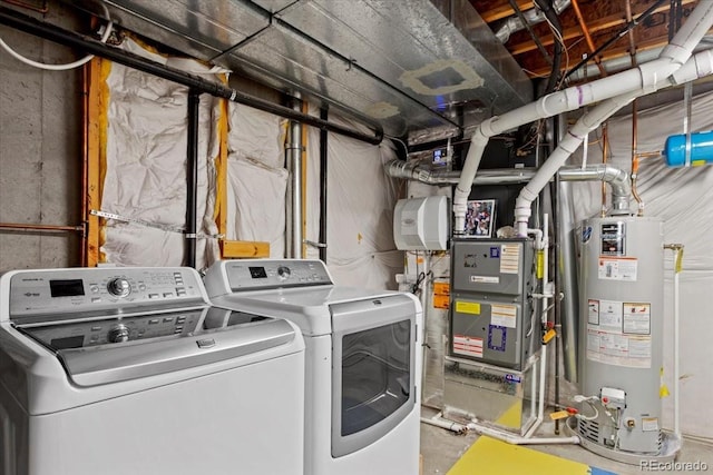 laundry area with laundry area, washer and clothes dryer, gas water heater, and heating unit