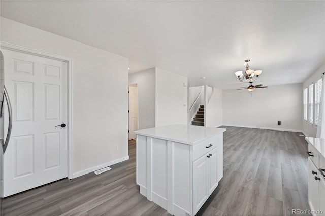 kitchen featuring baseboards, an inviting chandelier, and wood finished floors