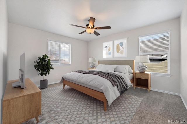 bedroom featuring baseboards, light carpet, and ceiling fan