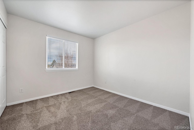 spare room with carpet floors and baseboards