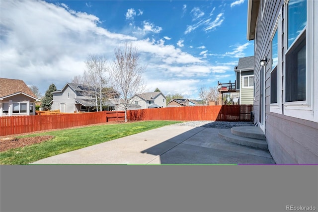 exterior space featuring a residential view, a patio, and a fenced backyard