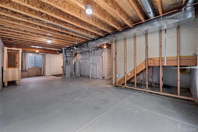 unfinished below grade area featuring heating unit and water heater