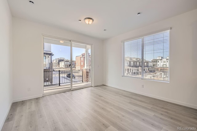 unfurnished room with light hardwood / wood-style floors