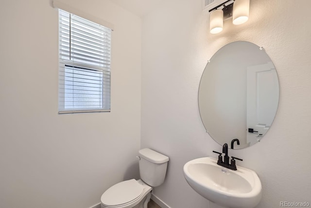 bathroom featuring toilet and sink