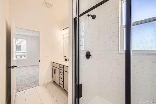 bathroom featuring tile patterned flooring, vanity, and a shower with door