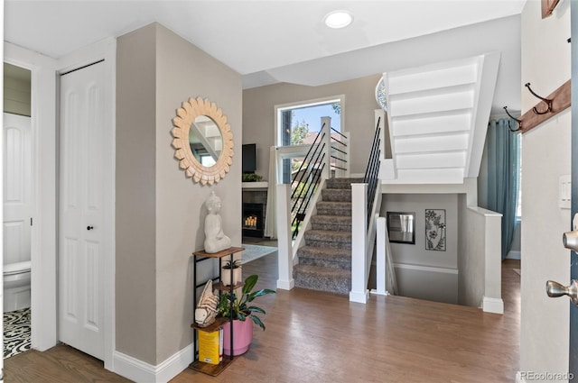 stairs featuring wood-type flooring