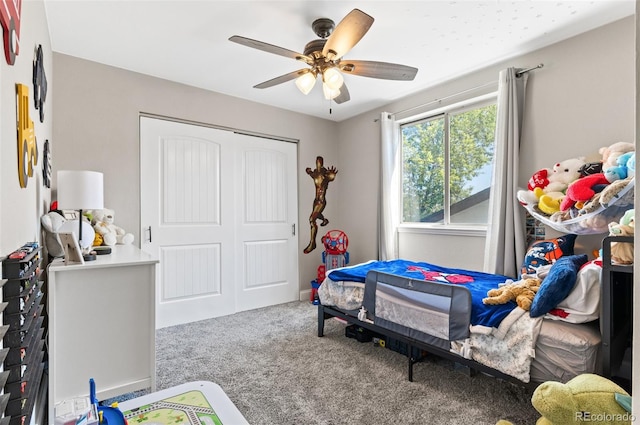 bedroom featuring ceiling fan, a closet, and carpet flooring