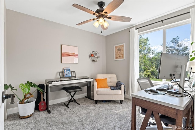 carpeted office featuring ceiling fan