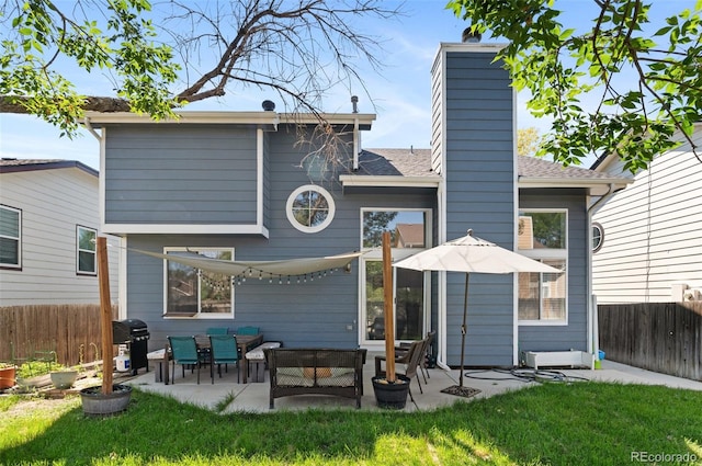 rear view of house featuring an outdoor living space, a lawn, and a patio area