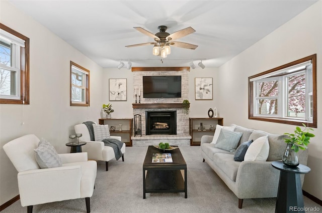 3190 Ward Ct, Wheat Ridge, CO 80215 - carpeted living area featuring healthy amount of natural light, a brick fireplace, a ceiling fan, and track lighting