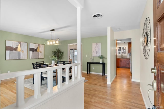 3190 Ward Ct, Wheat Ridge, CO 80215 - foyer entrance with light wood-style flooring, baseboards, and a chandelier