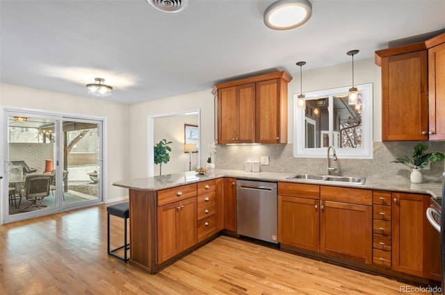 3190 Ward Ct, Wheat Ridge, CO 80215 - kitchen with dishwasher, a sink, a peninsula, and brown cabinets
