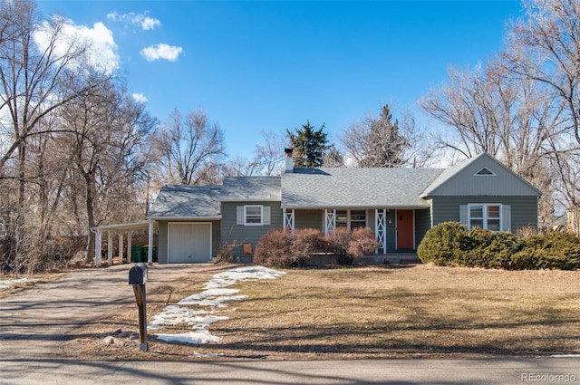 view of front of house with a carport, a garage, and a front lawn