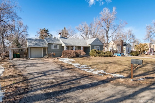 single story home featuring a garage and a carport