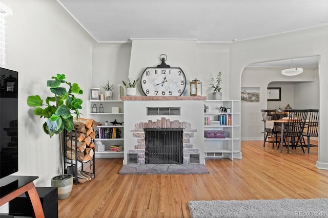 living room with hardwood / wood-style flooring and a fireplace