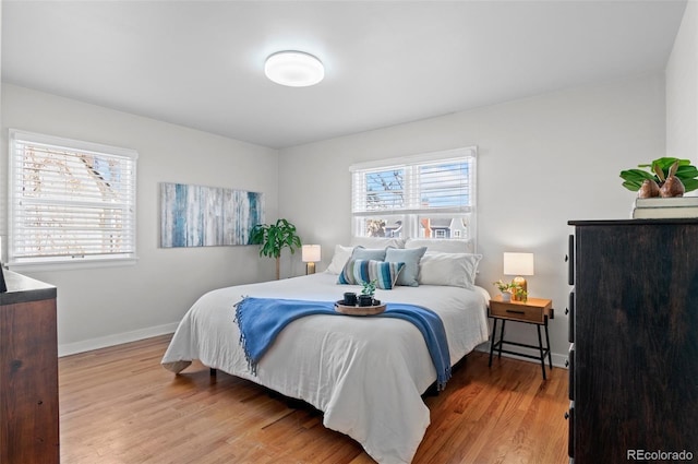 bedroom featuring multiple windows and hardwood / wood-style floors