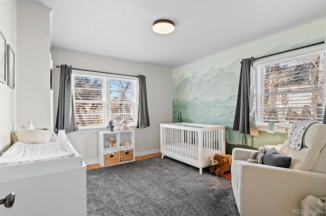 bedroom featuring a crib and dark wood-type flooring