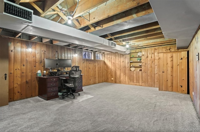 office space featuring carpet floors and wood walls