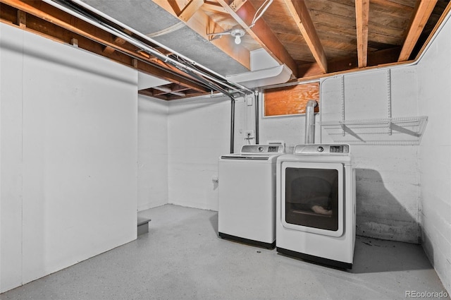 clothes washing area with washer and clothes dryer