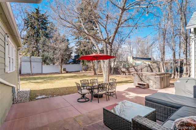 view of patio with a storage unit and a hot tub