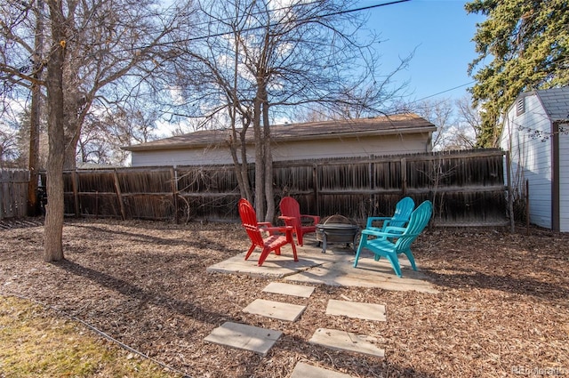 view of yard with a patio area and an outdoor fire pit