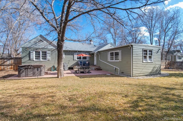 rear view of house with a patio area and a lawn