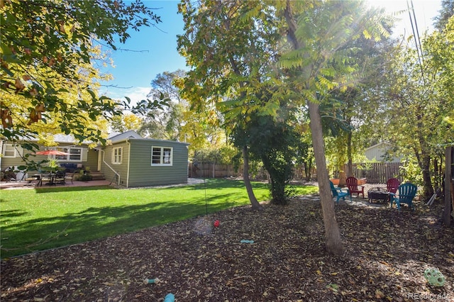 view of yard with an outdoor fire pit and an outdoor structure