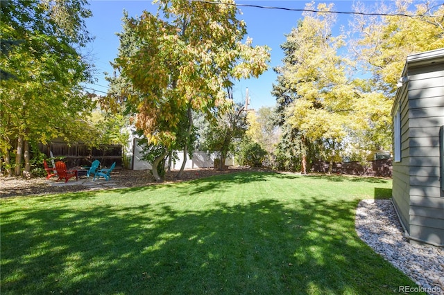 view of yard featuring an outdoor fire pit