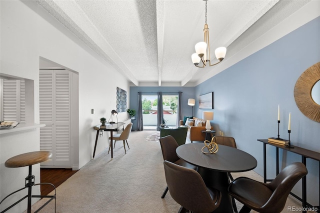 dining room featuring a textured ceiling, a notable chandelier, and wood-type flooring