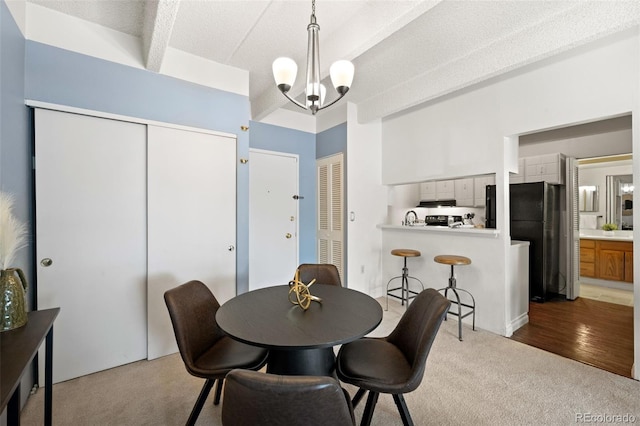 dining room featuring a textured ceiling, a chandelier, and wood-type flooring