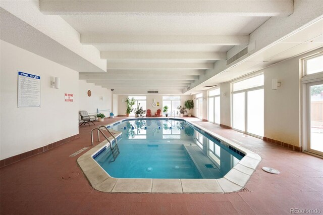 view of swimming pool featuring a hot tub