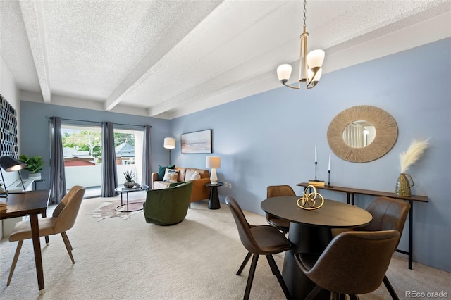 dining room with beam ceiling, a chandelier, a textured ceiling, and carpet