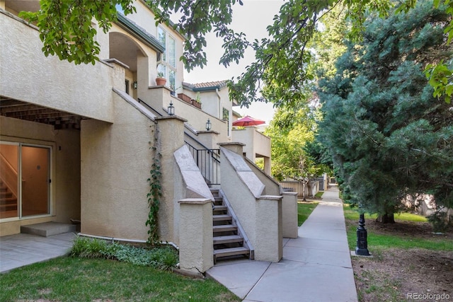 surrounding community featuring a patio area and stairs