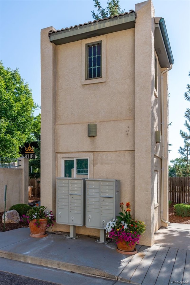 exterior space featuring mail area and fence