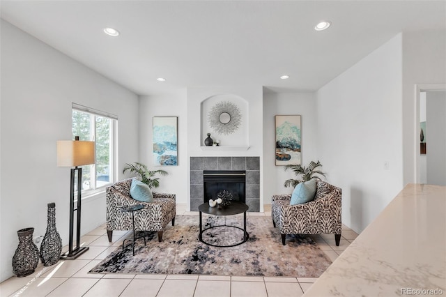 tiled living room featuring a tiled fireplace and recessed lighting