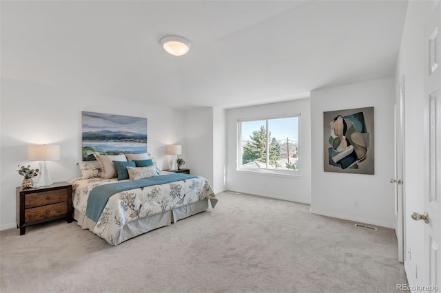 carpeted bedroom featuring baseboards and visible vents